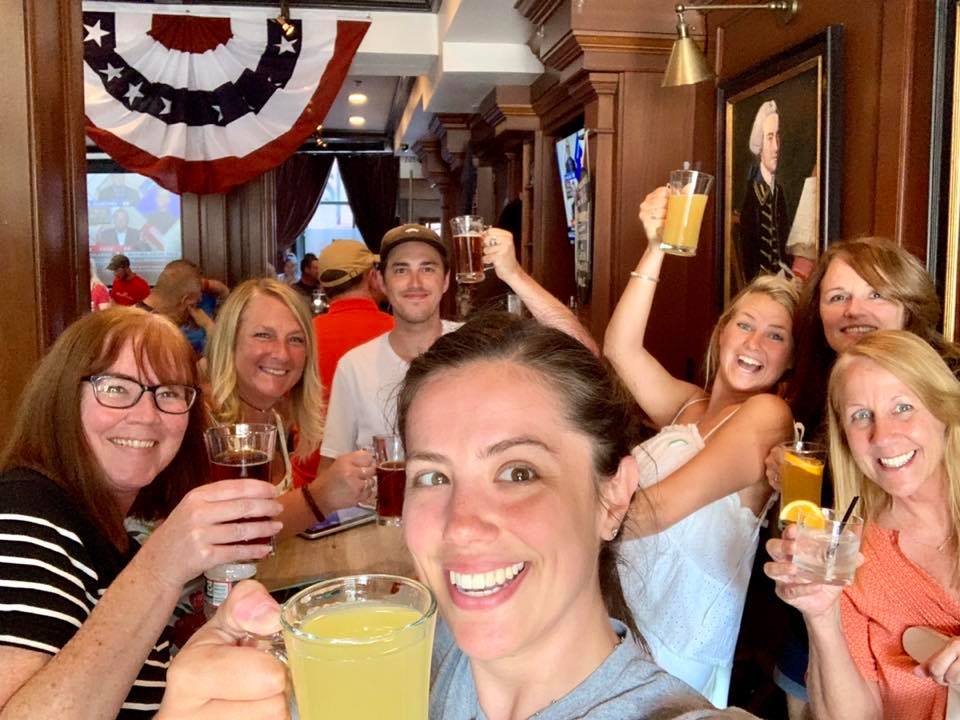 Boston Crawling – Independence Pub Crawl – 4 a group of people are drinking from a wine glass posing for the camera