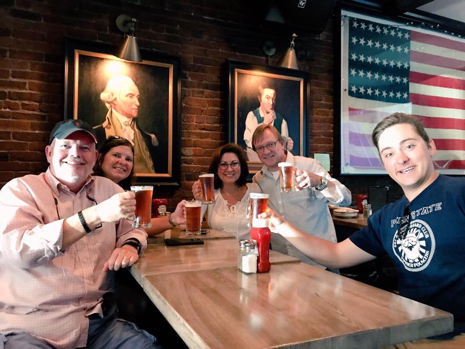 a group of people sitting at a table with wine glasses