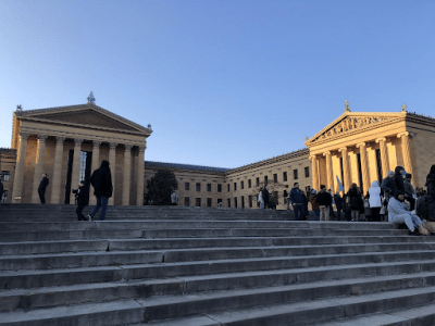 a group of people walking in front of a building