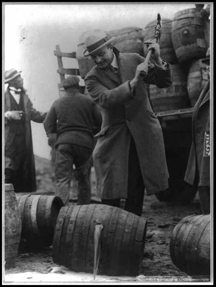 a group of people standing in front of a barrel